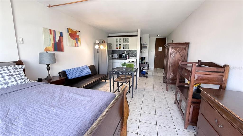 A studio apartment features a bed, a sofa, a small dining table, and a kitchenette — 37 ISLA VERDE AVE, CAROLINA, PR