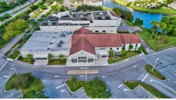 An aerial view shows a commercial building with a red roof and adjacent parking lot — 449 Fanshaw K # 449, Boca Raton FL 33434, BOCA RATON, FL