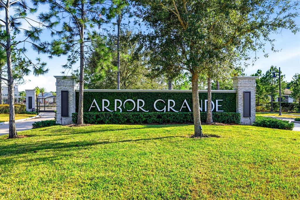 A stone monument sign with the name Arbor Grande sits in a grassy landscape — 12021 PERENNIAL PLACE, LAKEWOOD RANCH, FL
