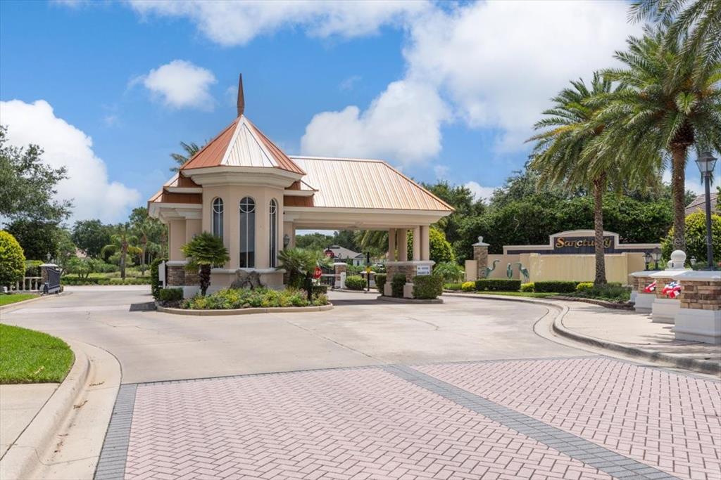A modern single-story house with a paved driveway, two-car garage, and palm trees in front — 17 OLD OAK DRIVE N, PALM COAST, FL