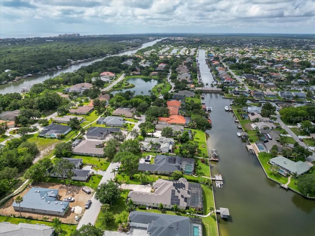 An aerial view shows waterfront houses along a canal in a residential neighborhood — 17 OLD OAK DRIVE N, PALM COAST, FL