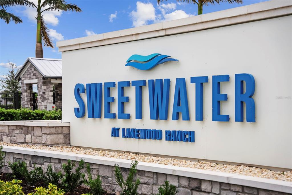 A sign for Sweetwater at Lakewood Ranch stands in front of a stone wall — 17510 SAVORY MIST CIRCLE, BRADENTON, FL