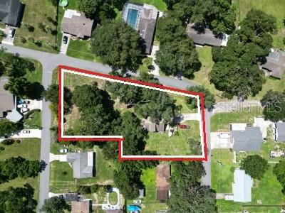 This aerial view shows a residential lot outlined in red within a suburban neighborhood — 35833 LAKESHORE DRIVE, DADE CITY, FL