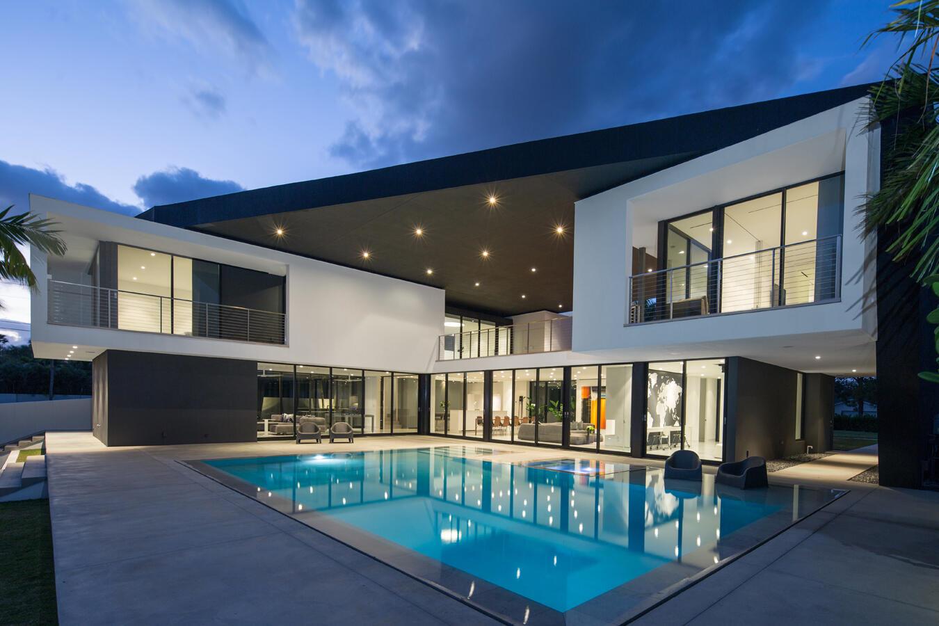 A modern two-story house with a large swimming pool and a covered outdoor patio area — 5706 Holly Lane, Jupiter FL 33458, JUPITER, FL