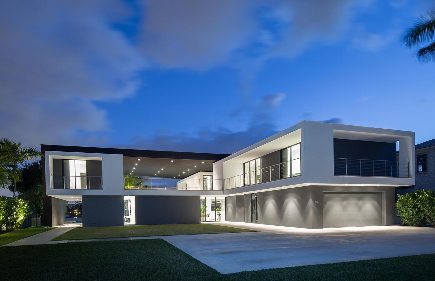 A modern two-story house with a flat roof, white and dark gray exterior, and garage — 5706 Holly Lane, Jupiter FL 33458, JUPITER, FL
