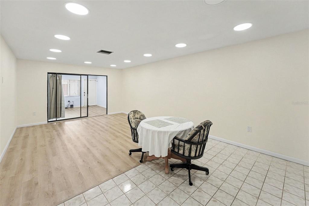 A room with a mix of tile and wood-look flooring and a small dining set — 5870 38TH AVENUE N UNIT 43, ST PETERSBURG, FL