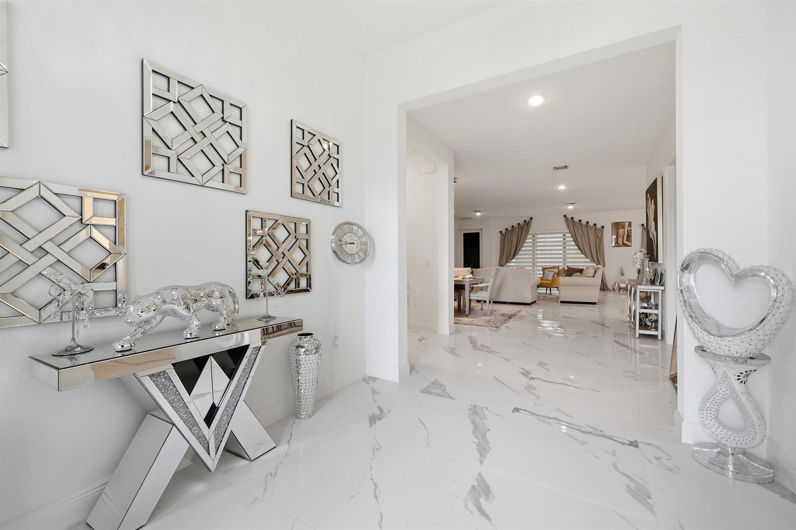 A bright foyer with white marble floors leads into an open-concept living and dining area — 5395 Saint Vincent Lane, FL 33470, FL