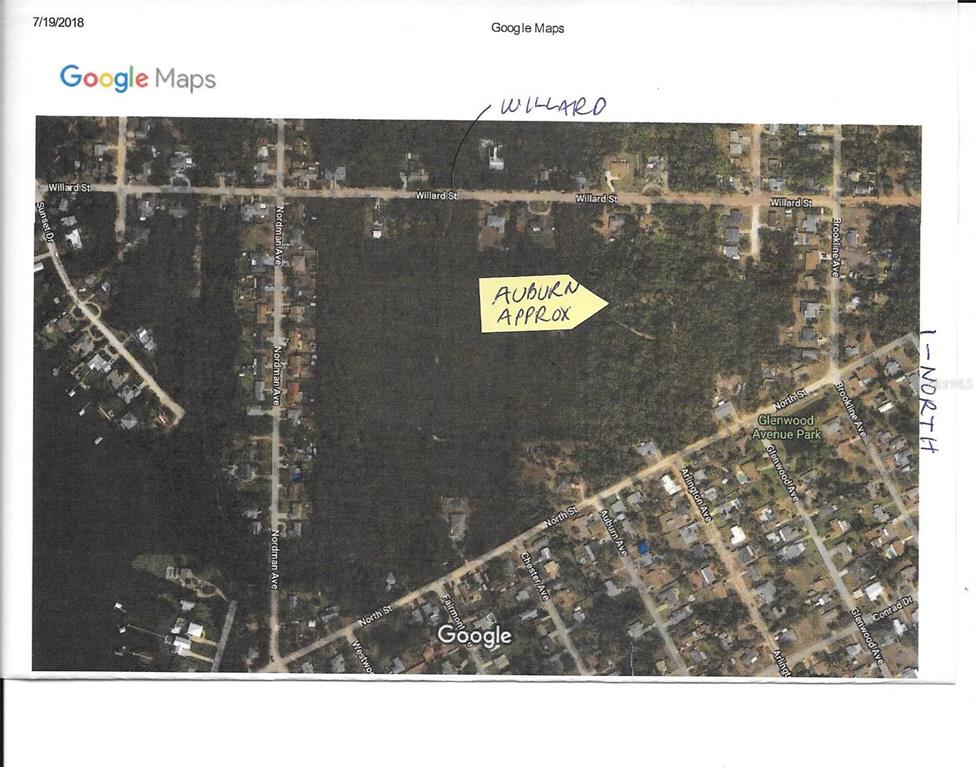 This is a satellite map showing residential streets and a wooded area — AUBURN AVENUE, NEW SMYRNA BEACH, FL
