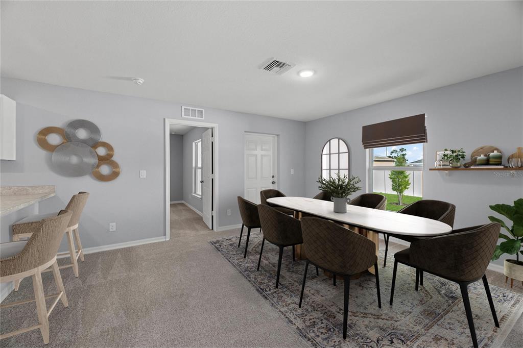 A dining room with a long table, chairs, and an adjacent breakfast bar area — 2295 W SWANSON DRIVE, CITRUS SPRINGS, FL