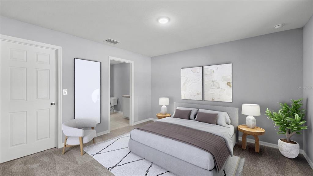 A bedroom features gray walls, a bed with a gray runner, and an attached bathroom — 2295 W SWANSON DRIVE, CITRUS SPRINGS, FL