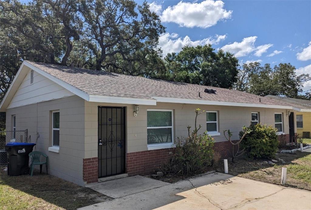 A single-story house with a concrete block exterior, brick accents, and a shingled roof — 511 N JOHN STREET, ORLANDO, FL