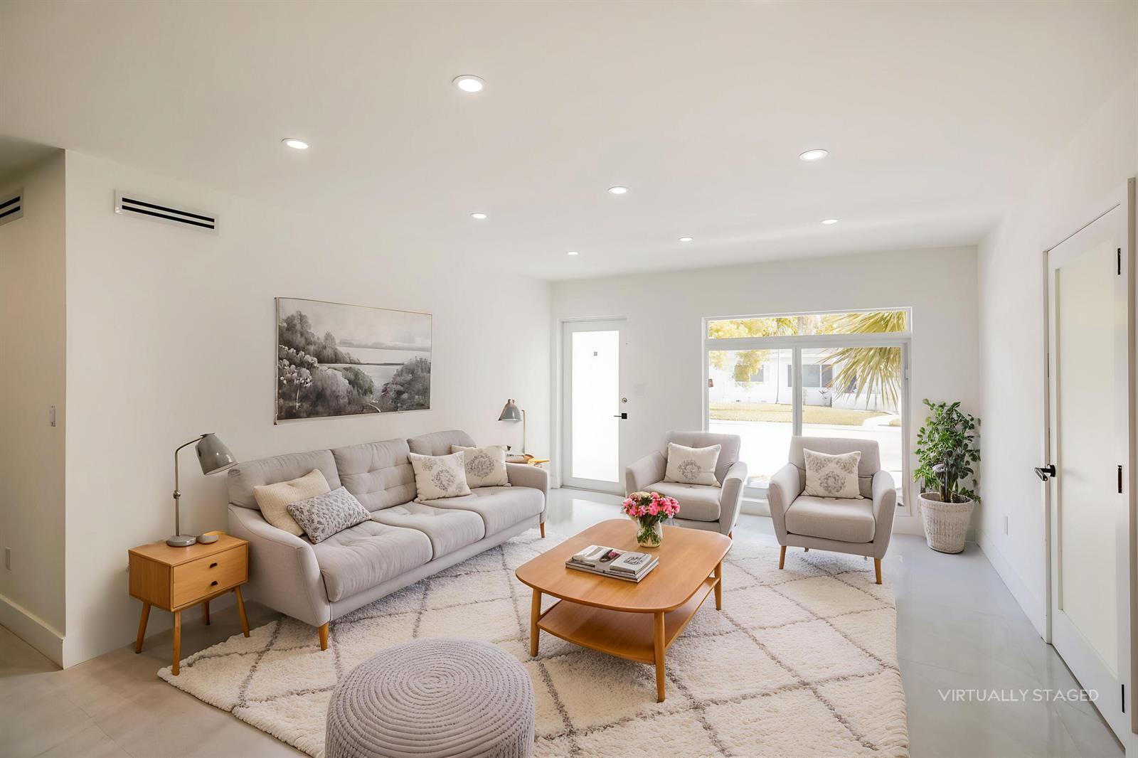 This virtually staged living room features a light gray sofa, two armchairs, and a rug — 4701 SW 7th Street, Miami FL 33134, MIAMI, FL
