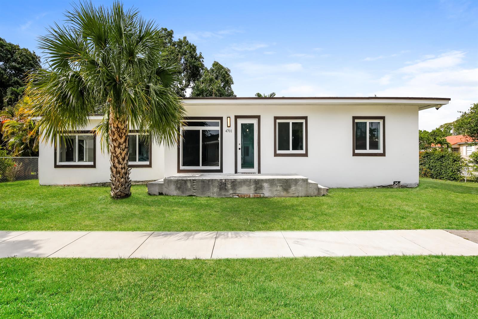A single-story white house with a concrete porch and a palm tree in the yard — 4701 SW 7th Street, Miami FL 33134, MIAMI, FL