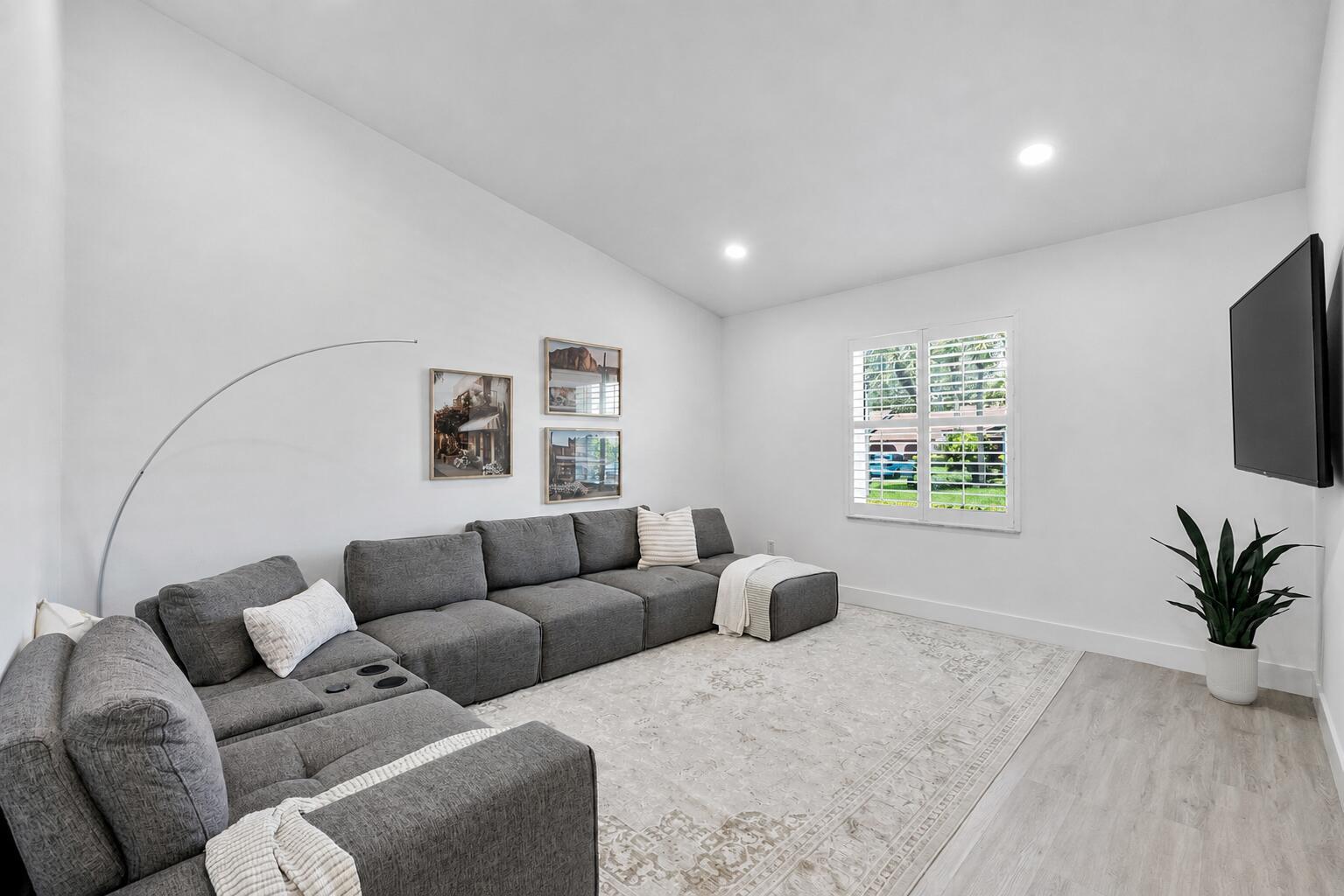 A living room features a large gray sectional sofa, a patterned area rug, and a television — 23284 SW 53rd Avenue # D, Boca Raton FL 33433, BOCA RATON, FL