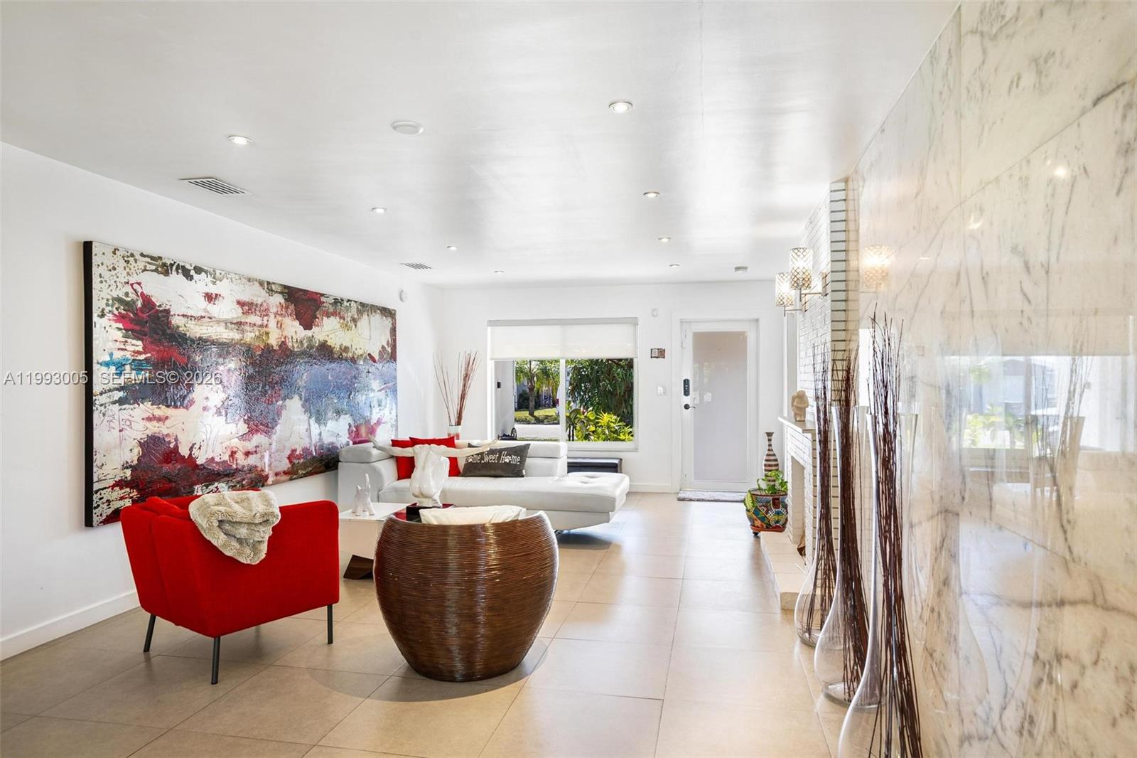A living room features a large abstract painting, a red armchair, and a white sofa — 2923 Madison St, Hollywood FL 33020, HOLLYWOOD, FL