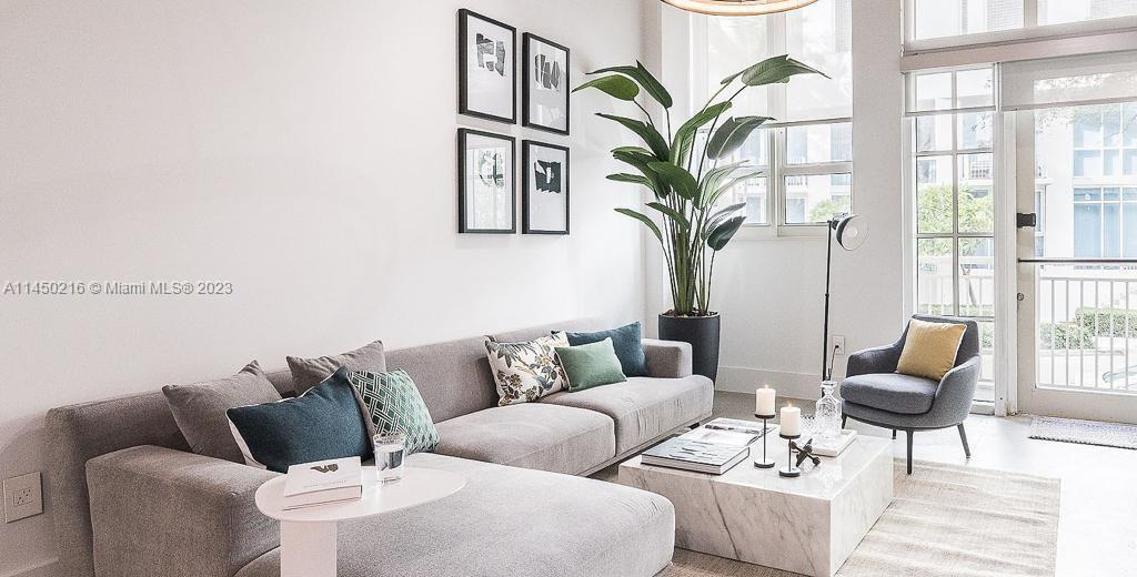 A modern living room features a gray sectional sofa, marble coffee table, and large plant — 2001 Biscayne Blvd # 2104, Miami FL 33137, MIAMI, FL