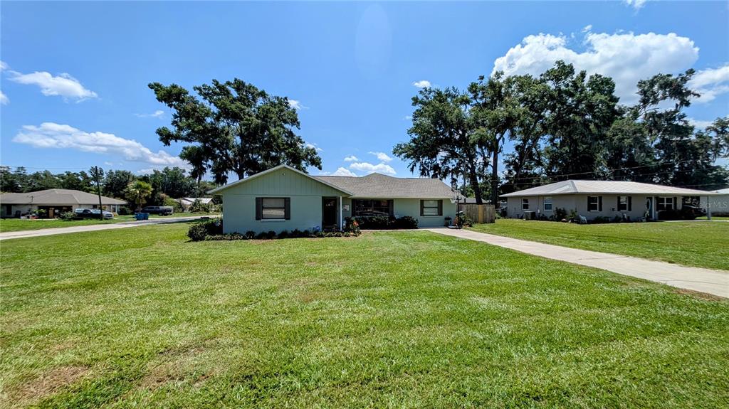 A single-story house with a light green exterior and a large front lawn — 624 N LANIER AVENUE, FORT MEADE, FL