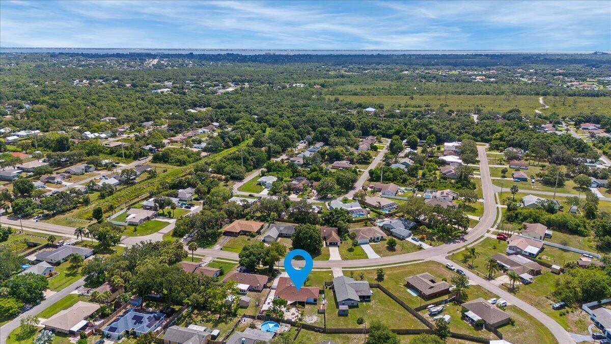 An aerial view shows a single-story house with a blue marker in a suburban neighborhood — 2350 Fallon Boulevard NE, Palm Bay FL 32907, PALM BAY, FL
