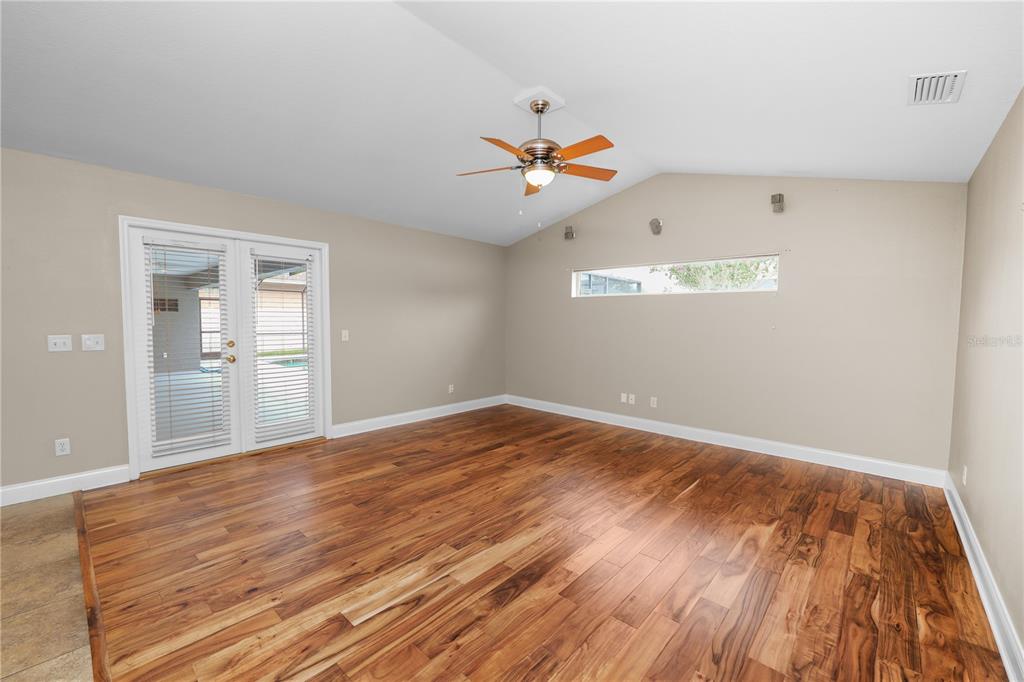 A kitchen features white cabinets, granite countertops, stainless steel appliances, and tile flooring — 3333 HAWKS RIDGE DRIVE, LAKELAND, FL