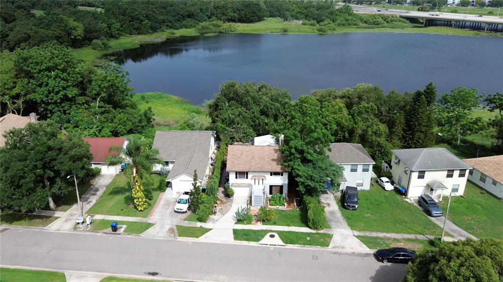 An aerial view shows a row of houses situated along a street near a lake — 238 LAKE DRIVE, ORLANDO, FL