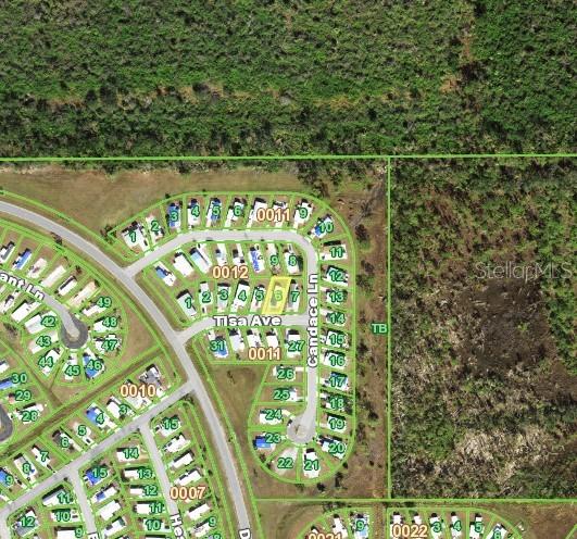 This is an aerial map showing a residential neighborhood with a highlighted property lot — 7360 TISA AVENUE, PORT CHARLOTTE, FL