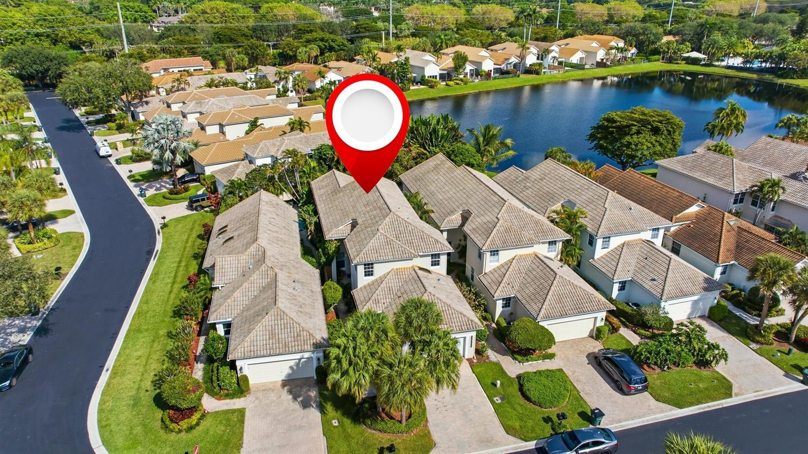 An aerial view shows a residential townhouse with a tiled roof near a lake — 2495 NW 66th Drive, Boca Raton FL 33496, BOCA RATON, FL