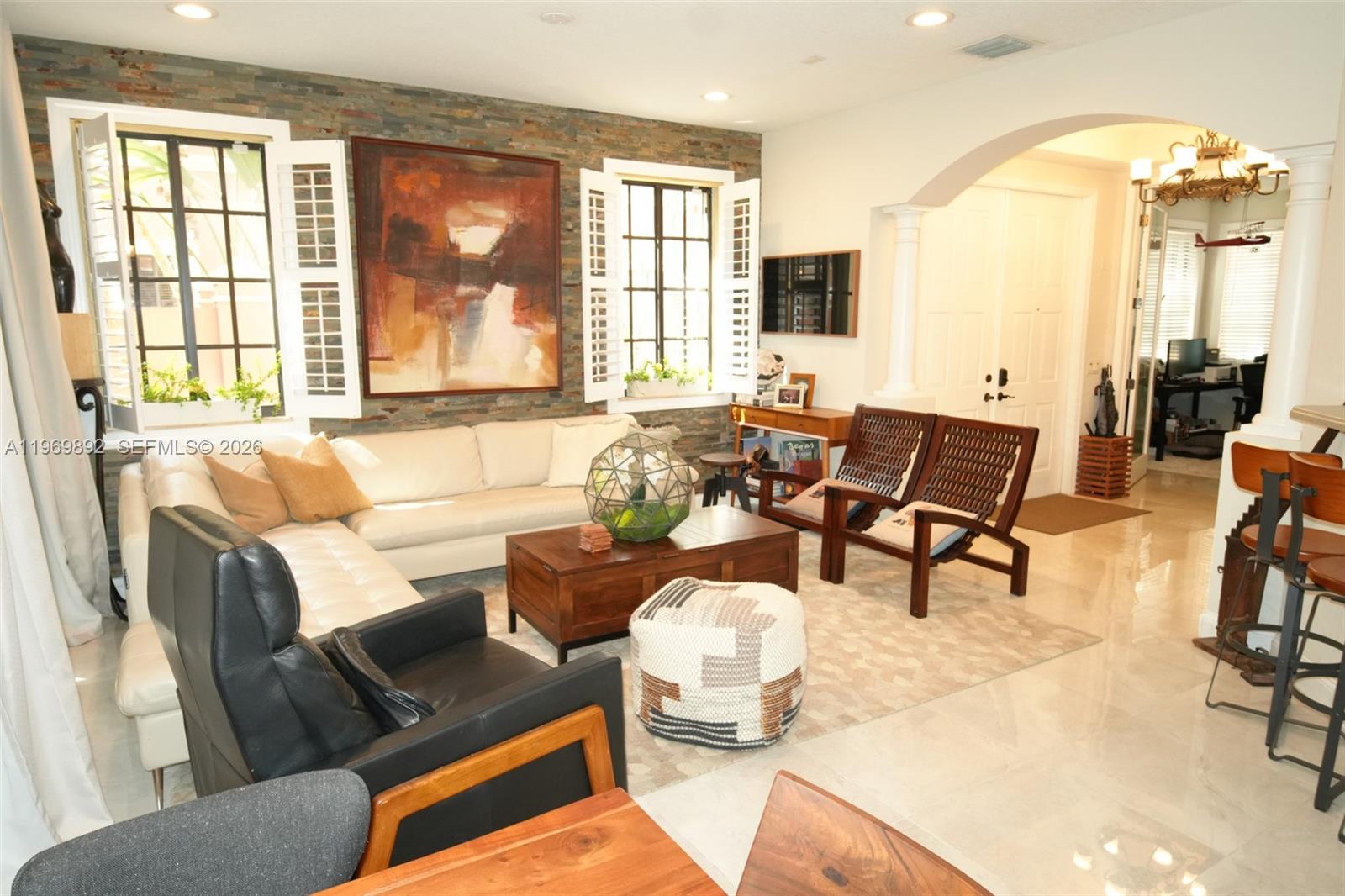 A living room features a stone accent wall, white sectional sofa, and dark wood furniture — 2706 Kinsington Cir # 2, Weston FL 33332, WESTON, FL