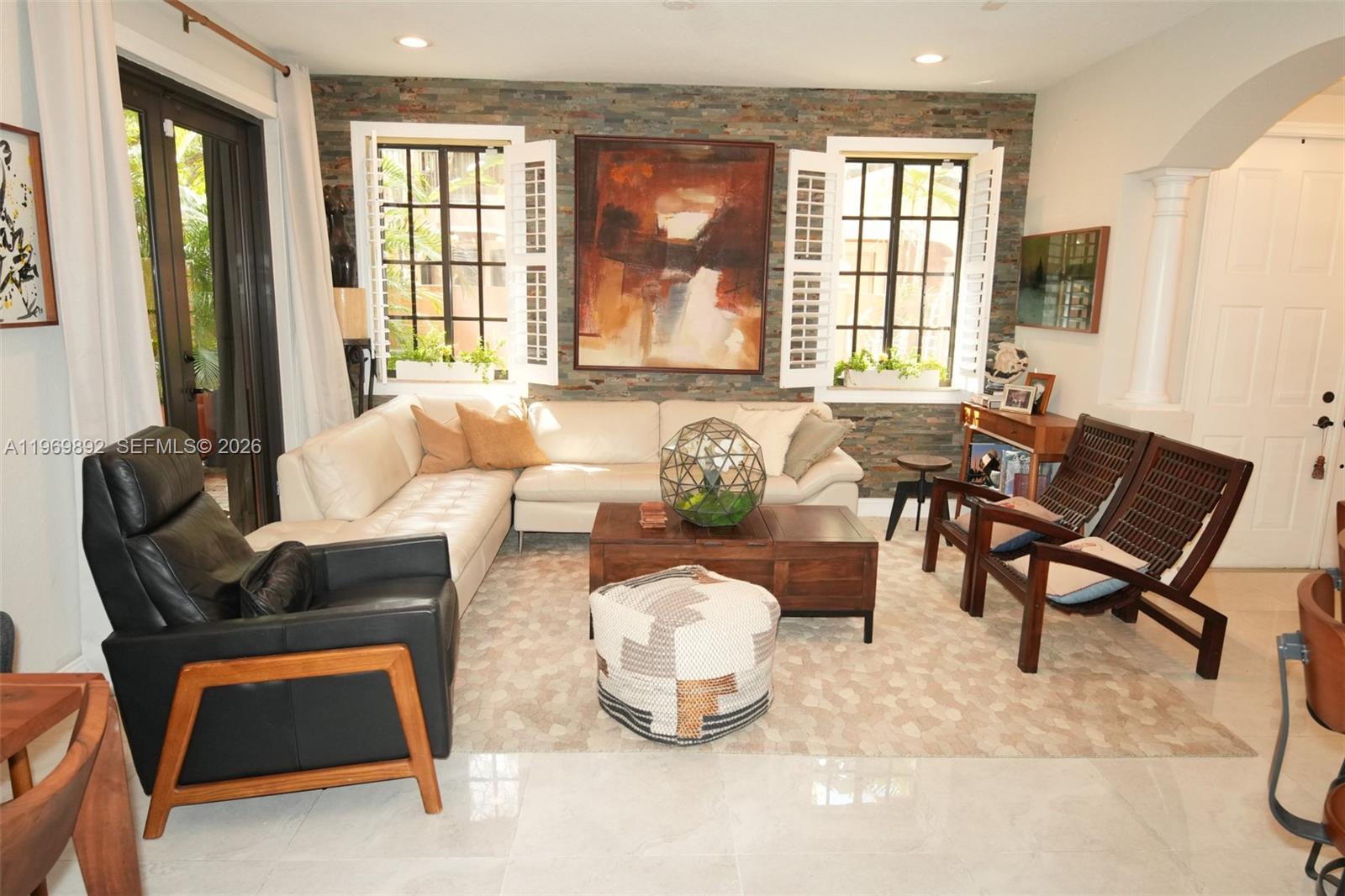A living room features a stone accent wall, white sectional sofa, and dark wood furniture — 2706 Kinsington Cir # 2, Weston FL 33332, WESTON, FL