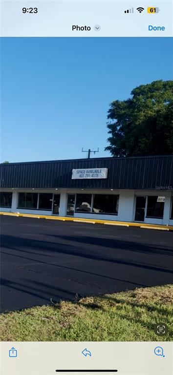 A single-story commercial building with a black metal roof and a large asphalt parking lot — 1780 E DUVAL STREET Unit 120, LAKE CITY, FL