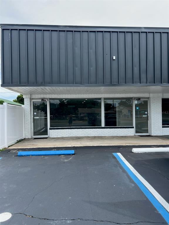 The exterior of a commercial building features a dark metal facade and white brick walls — 1780 E DUVAL STREET Unit 120, LAKE CITY, FL