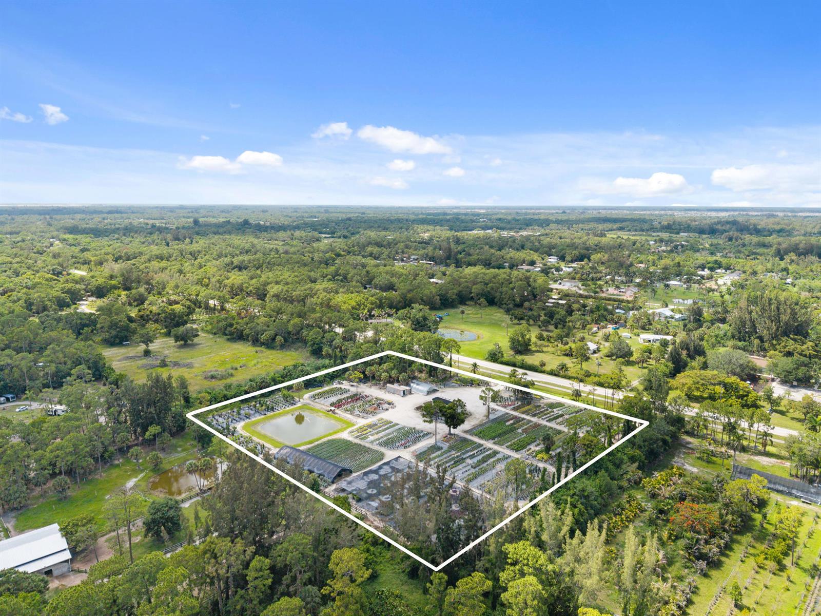 An aerial view shows a plant nursery with rows of crops and a small pond — 14650 Okeechobee Boulevard, FL 33470, FL