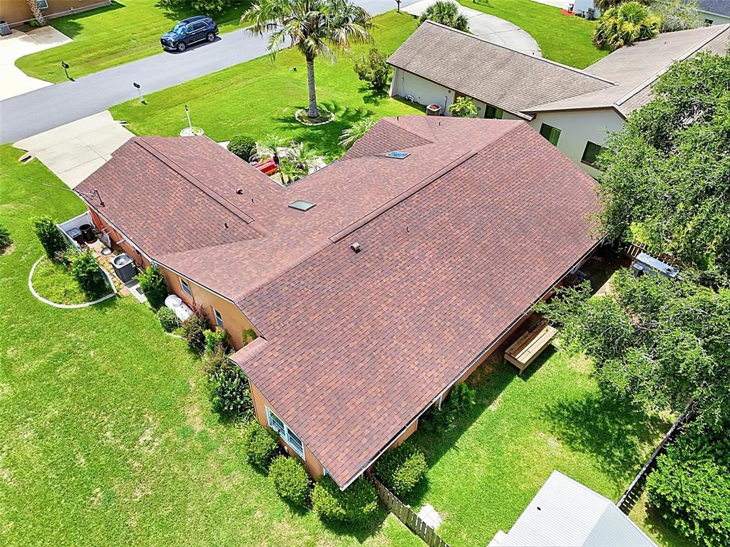An aerial view of a residential house with a brown shingled roof and surrounding yard — 2 WINDERMERE PLACE, PALM COAST, FL