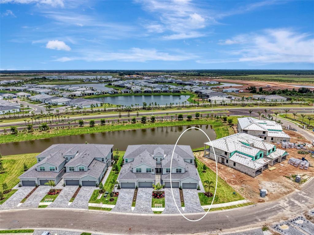 An aerial view shows a multi-family residential building with a circled end unit — 19227 CHERRYSTONE WAY UNIT #104, LAKEWOOD RANCH, FL