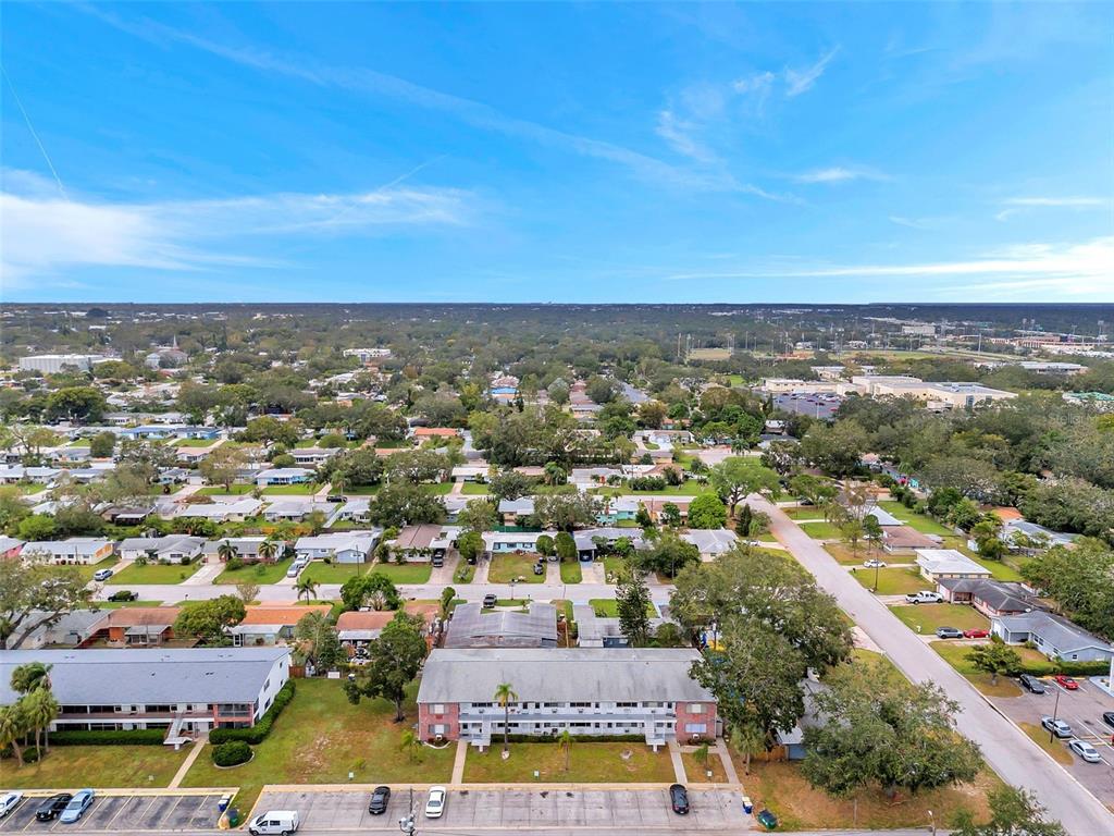 An aerial view shows a multi-story apartment building surrounded by residential streets and trees — 2366 SHELLEY STREET UNIT 10, CLEARWATER, FL