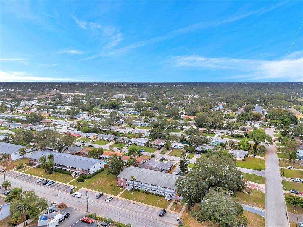 An aerial view shows multi-story apartment buildings surrounded by residential streets and trees — 2366 SHELLEY STREET UNIT 10, CLEARWATER, FL