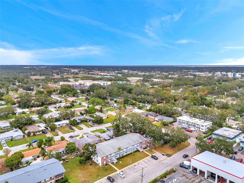 An aerial view shows a residential neighborhood with apartment buildings, parking lots, and surrounding trees — 2366 SHELLEY STREET UNIT 10, CLEARWATER, FL