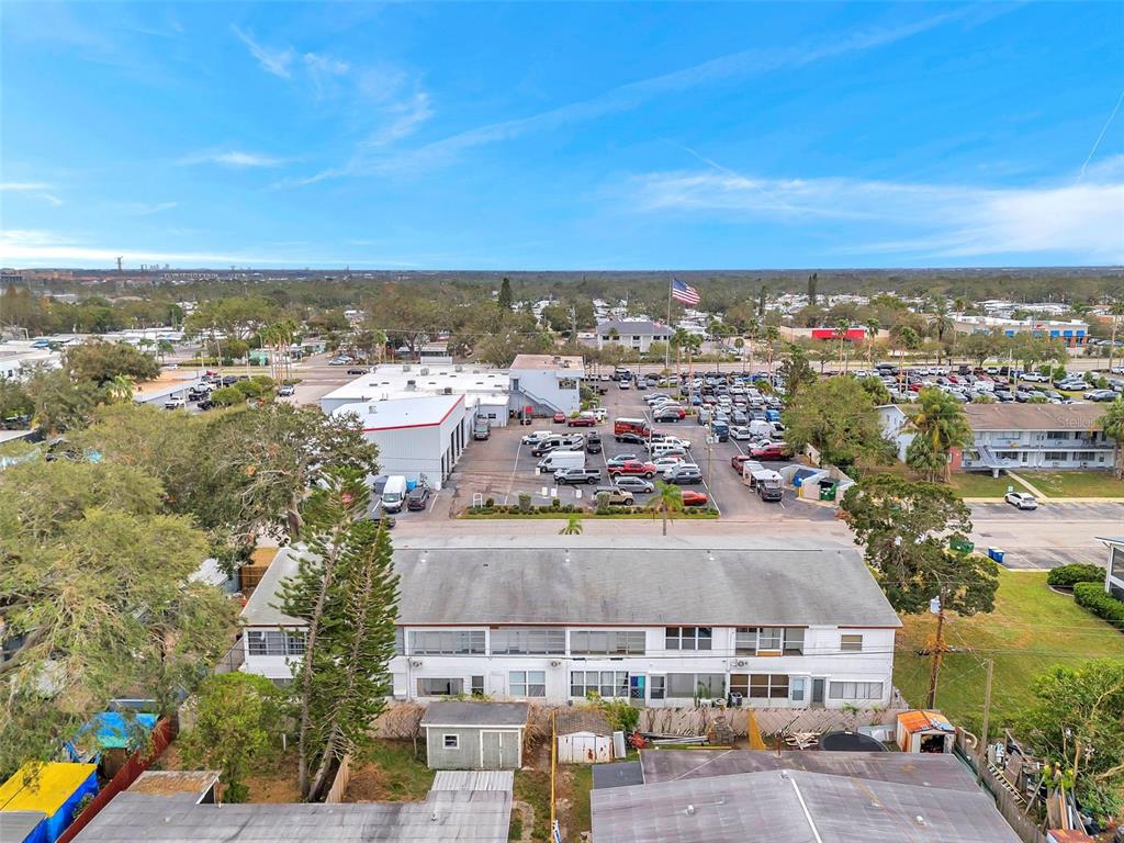 An aerial view shows a multi-story apartment building, a parking lot, and surrounding commercial properties — 2366 SHELLEY STREET UNIT 10, CLEARWATER, FL