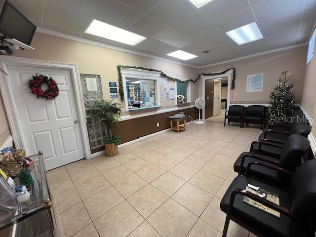 A waiting room features tile flooring, a reception window, and rows of black chairs — 101 CLEARWATER LARGO ROAD N, LARGO, FL