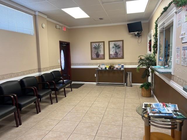 A waiting room features black chairs, a glass table, and framed artwork on the walls — 101 CLEARWATER LARGO ROAD N, LARGO, FL