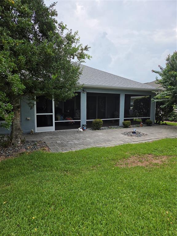 A bedroom features a wooden bed frame, a large wardrobe, a dresser, and hardwood floors — 1569 ANDREWS AVENUE, THE VILLAGES, FL