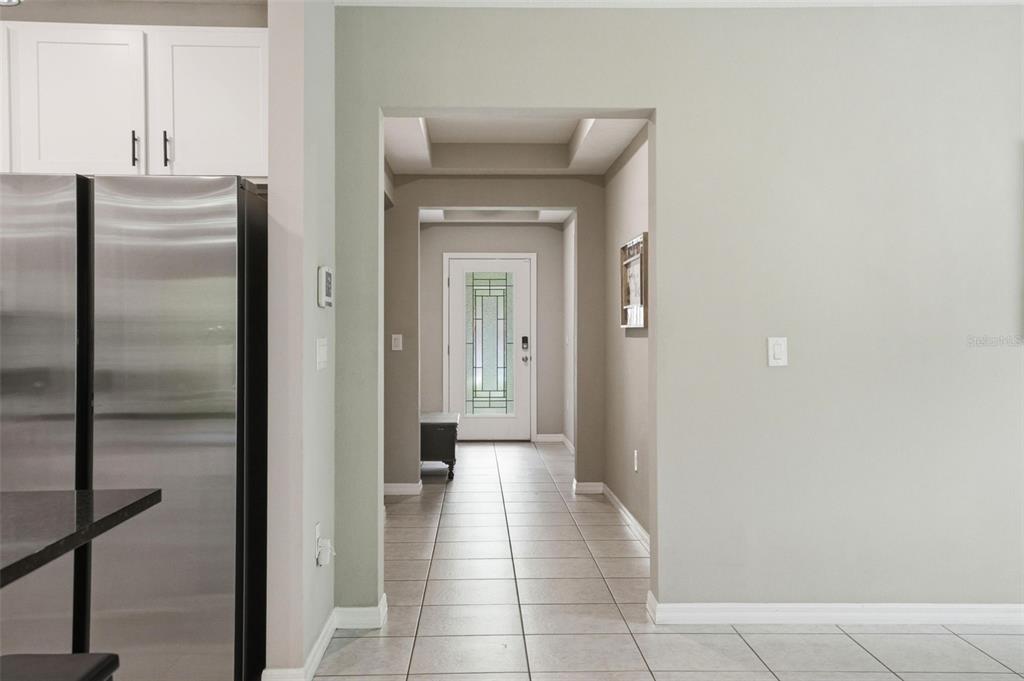 A hallway with tiled floors leads to a front door with a decorative glass insert — 39 MILBARK DRIVE, HOMOSASSA, FL