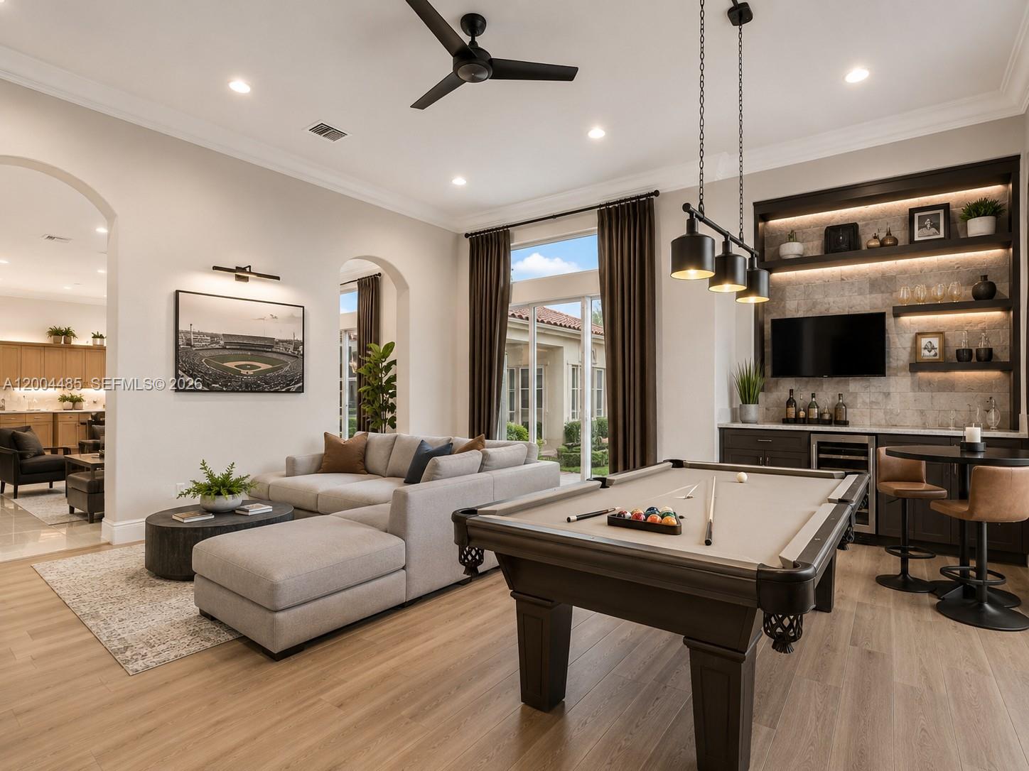 A living room features a sectional sofa, pool table, bar area, and large windows — 14857 SW 38th St, Davie FL 33331, DAVIE, FL