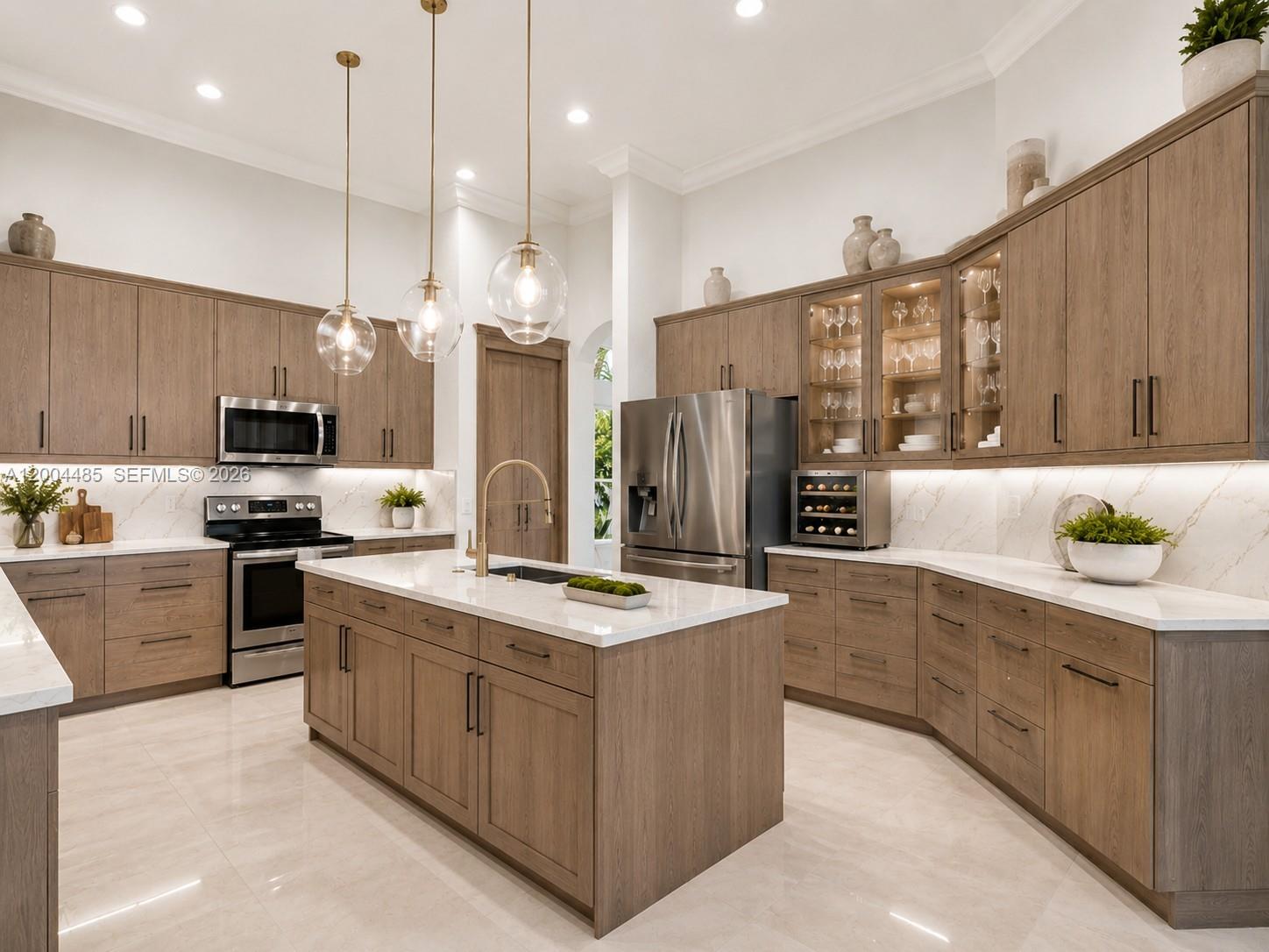 A modern kitchen features wood cabinets, a central island, stainless steel appliances, and marble countertops — 14857 SW 38th St, Davie FL 33331, DAVIE, FL