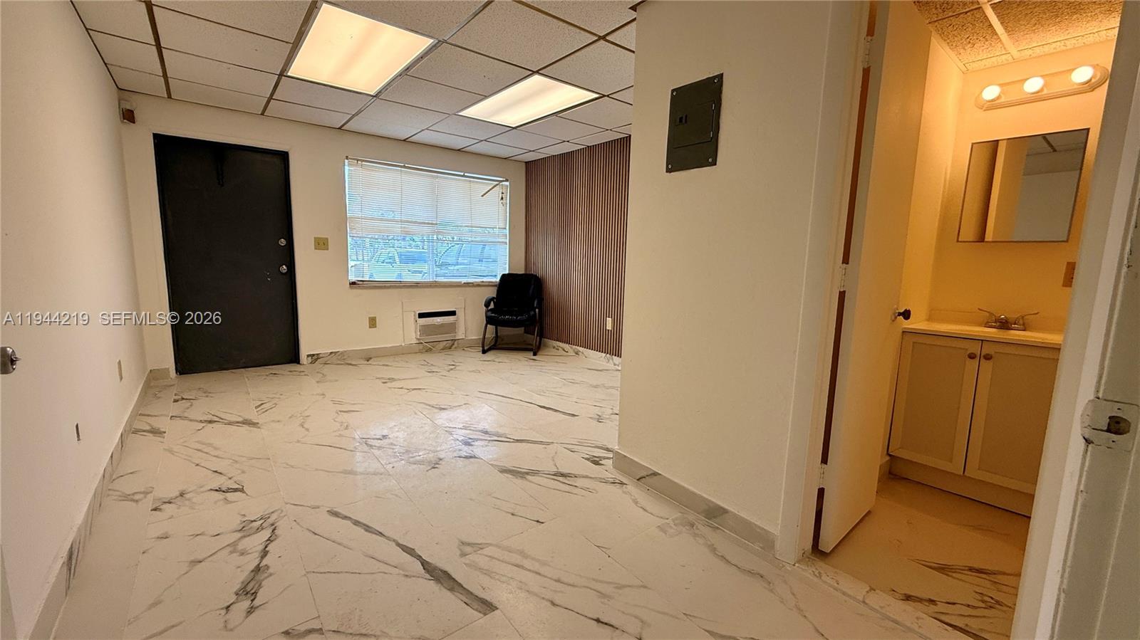 An office space features white marble-patterned tile flooring, a drop ceiling, and an attached bathroom — 500 NE 25th St # 5, Pompano Beach FL 33064, POMPANO BEACH, FL