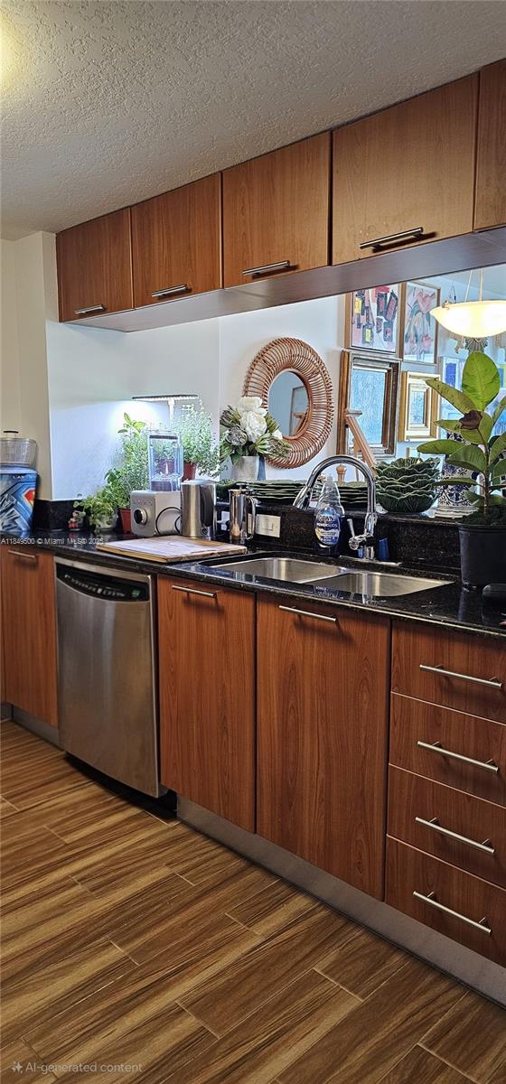A kitchen features wood-grain cabinets, black countertops, stainless steel appliances, and a tiled floor — 1800 N Bayshore Dr # 3808, Miami FL 33132, MIAMI, FL