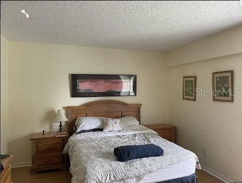 A bedroom features a wooden bed frame, two matching nightstands, and framed wall art — 293 DORSET G UNIT G, BOCA RATON, FL