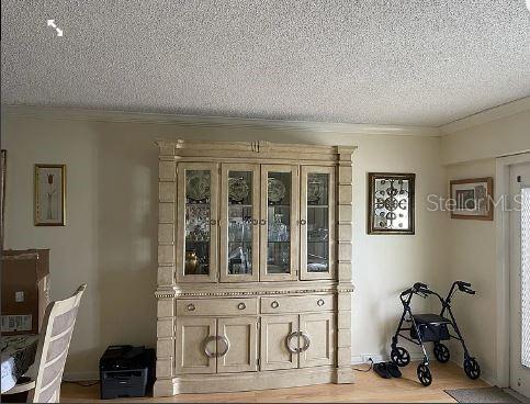 A dining room features a large wooden hutch, a walker, and a printer on the floor — 293 DORSET G UNIT G, BOCA RATON, FL