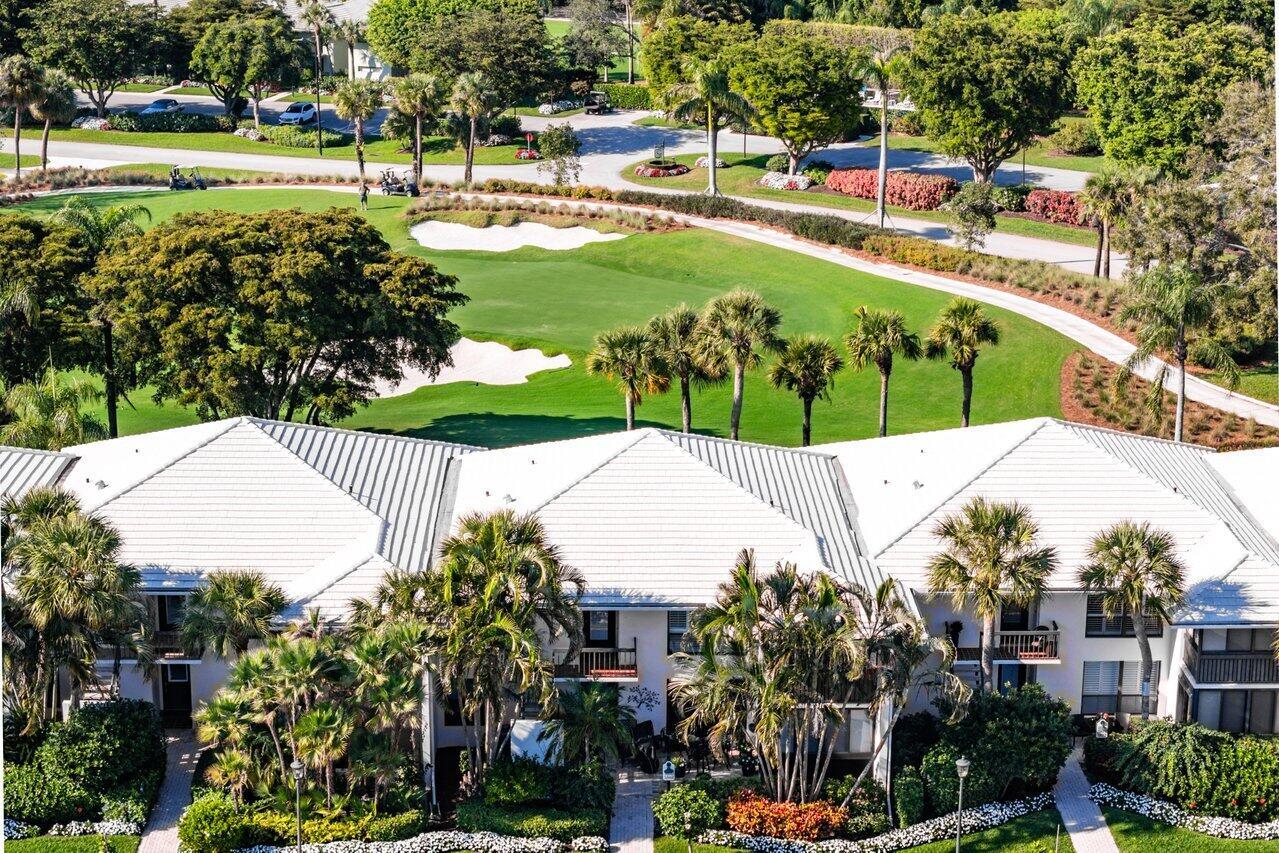 An aerial view of a multi-story residential building overlooking a golf course with sand traps — 3870 Quail Ridge Drive, Boynton Beach FL 33436, BOYNTON BEACH, FL