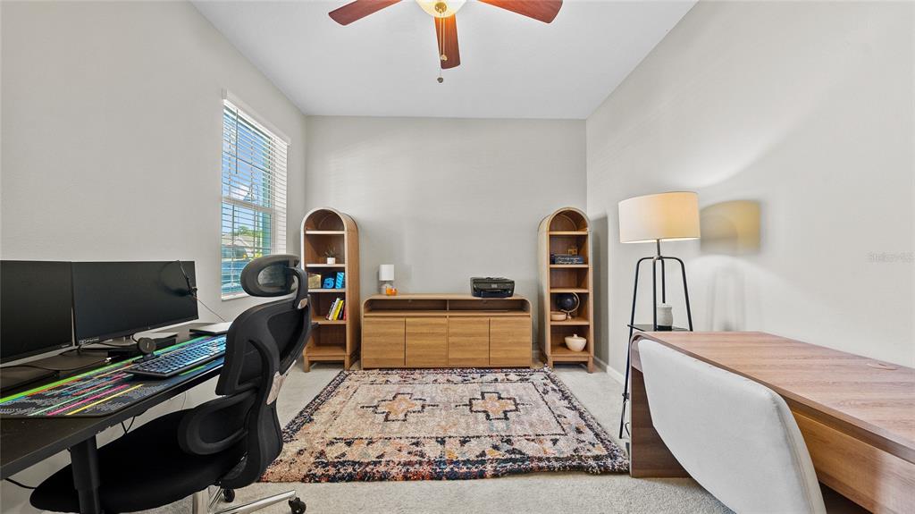 A dining area features a dark wood table, six chairs, and a modern pendant light — 891 JETWAY STREET, ORANGE CITY, FL