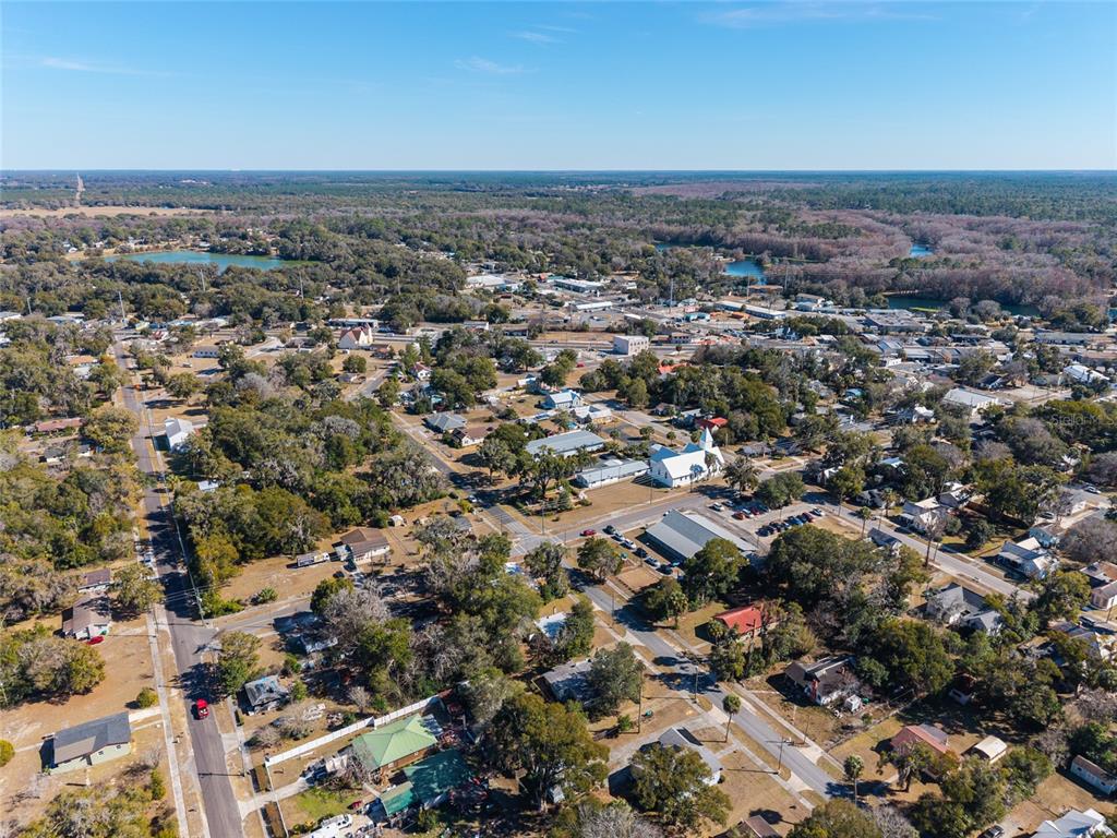 A small, single-story house with light-colored siding, a central front door, and concrete steps — 20707 PARK AVENUE, DUNNELLON, FL